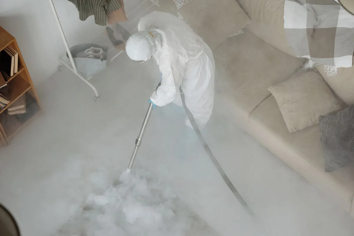 Biohazard cleanup technician in protective equipment, Littlefield Community, Detroit, MI